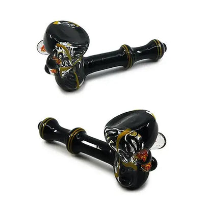 Marble Masterpiece black glass skull hand pipe with gold orange accents