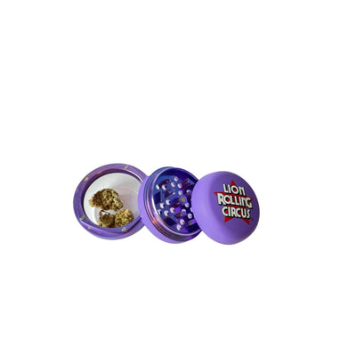 Nuevo grinder: Purple three-compartment, Lion Rolling Circus branding, herb material