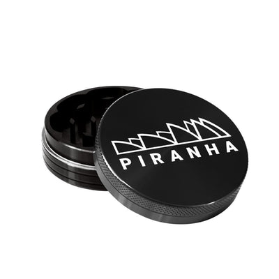 Compact Piranha Aluminum Grinder for grinding dry herbs, with ’PIRANHA’ logo on lid