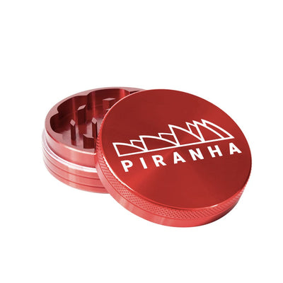 Piranha aluminum piece grinder for grinding dry herbs with ’PIRANHA’ branding on lid