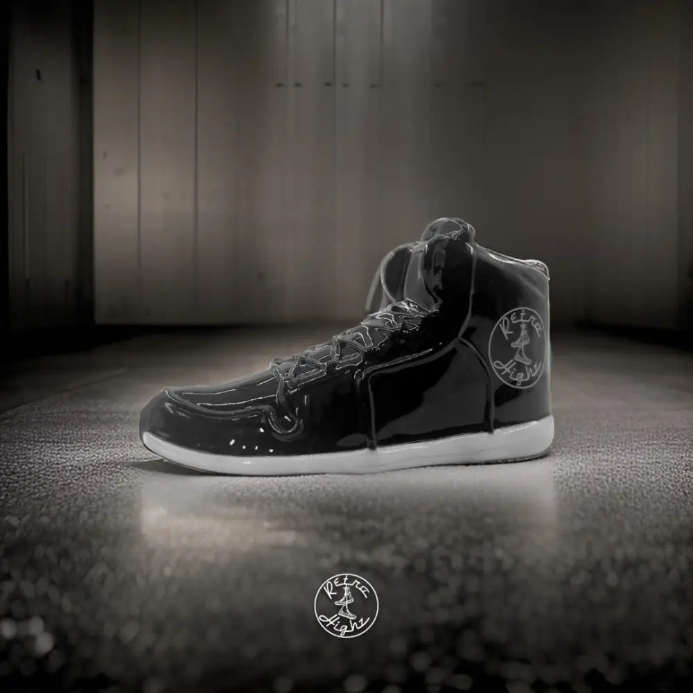 Shiny black high-top sneaker on Retro Highz glass hand pipe featuring collectable shoe design