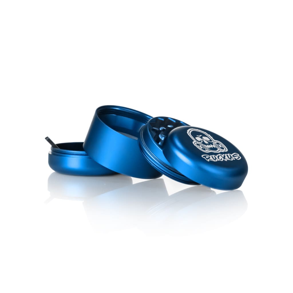 Disassembled blue Ruckus Aluminum Grinder with skull logo for Lion Rolling Circus hemp wraps