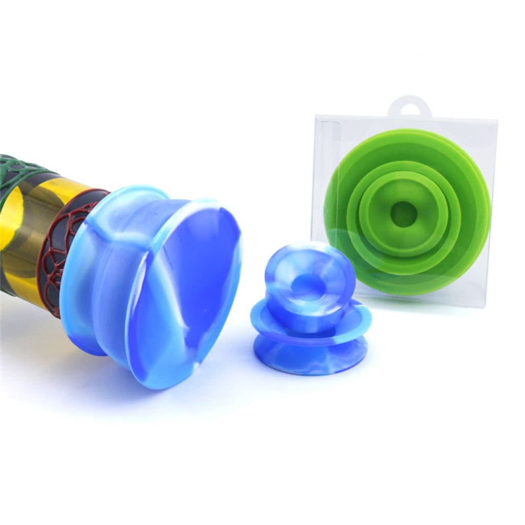 Colorful plastic kaleidoscope with blue and green attachments on silicone cleaner caps for glass water pipes