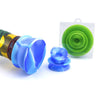 Colorful plastic kaleidoscope with blue and green attachments on silicone cleaner caps for glass water pipes