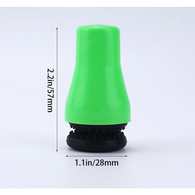 Bright green silicone magnetic cleaner for glass water pipes, featuring a black rubber base