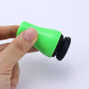 Silicone magnetic cleaner for glass water pipes: bright green with a black base held between fingers