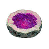 Sparkling geode ashtray with vibrant purple crystals and a rough exterior