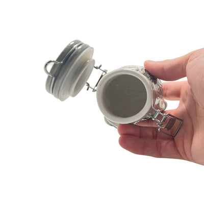 Ceramic storage jar with airtight lid being opened; perfect for elegant home decor