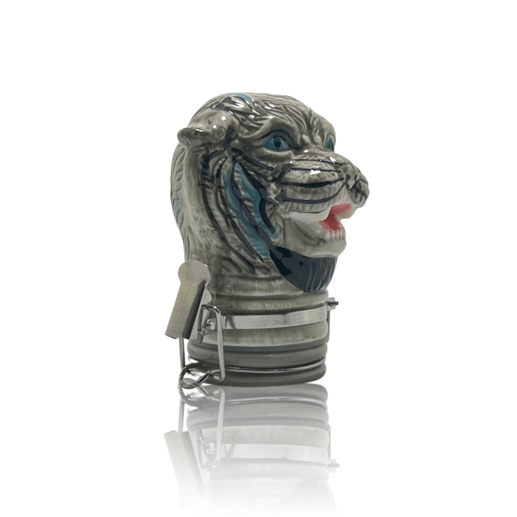 Fierce creature head figurine with blue eyes and red tongue on ceramic storage jars for home decor