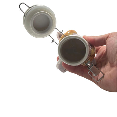 Hand holding a ceramic beer stein with lid, part of Ceramic Storage Jars for Elegant Home Decor