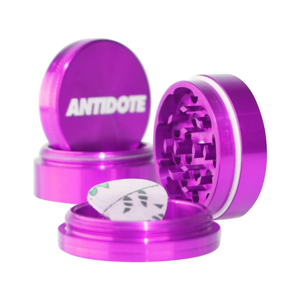 Purple metal herb grinder with ’ANTIDOTE’ branding, crafted from aircraft grade aluminum