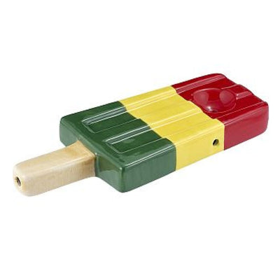 Colorful wooden popsicle-shaped whistle toy next to Ceramic Ice Pop Pipe in Rasta Colors