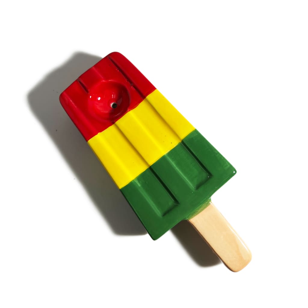 Ceramic ice pop pipe in rasta colors with red, yellow, and green stripes