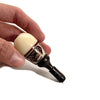 Bottle opener with white ceramic handle held near Colombian Tagua Seed hand pipe for discreet smoking