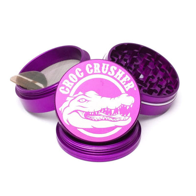 Croc Crusher Grinder With Diamond Teeth And Teflon Glide Ring Featuring a Crocodile Logo