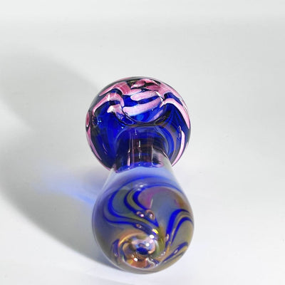 Blue dichroic nightshade glass pipe with pink and white accents showcasing color-changing features