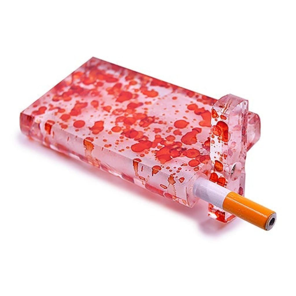 Clear lighter with red splatters, orange cigarette inside handmade acrylic dugout