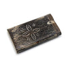 Handmade wooden flower dugout with a carved floral design on the rustic wooden box lid