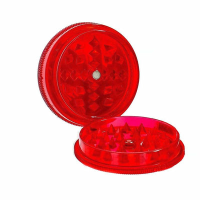 Red plastic herb grinder with transparent top featuring leaf print design