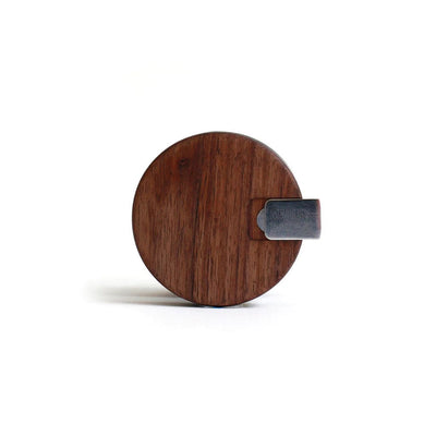 Circular wooden board with dark metal handle for Marley Natural Grinder, sustainably sourced black walnut