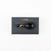 Smoked glass spoon pipe with gold stripe on black stem, on a dark gray box