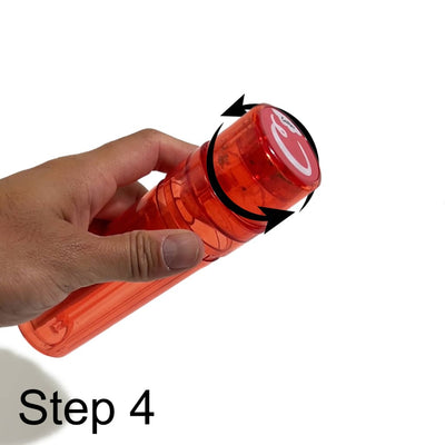 Red Coca-Cola bottle twisted open beside Portable Transparent Pre-roller for consistent filling