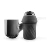 Portable coffee maker or espresso machine with cup next to Puffco Proxy dry herb vaporizer