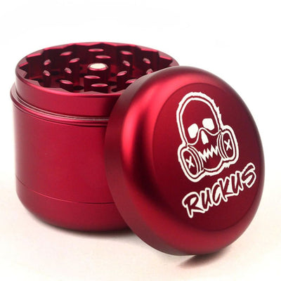 Red metal herb grinder with skull logo and Ruckus branding in custom Ruckus box