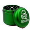 Green metal herb grinder with skull logo, part of Ruckus Black 4-Piece in custom Ruckus box