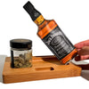 Bottle of Jack Daniel’s over wooden tray with cannabis and resealable zipper bags for dry herb