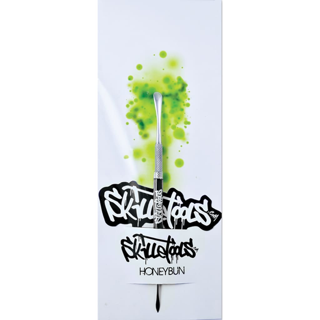 Metallic dabber tool with green splatter and graffiti text for Comfort Grip Skillet Tools