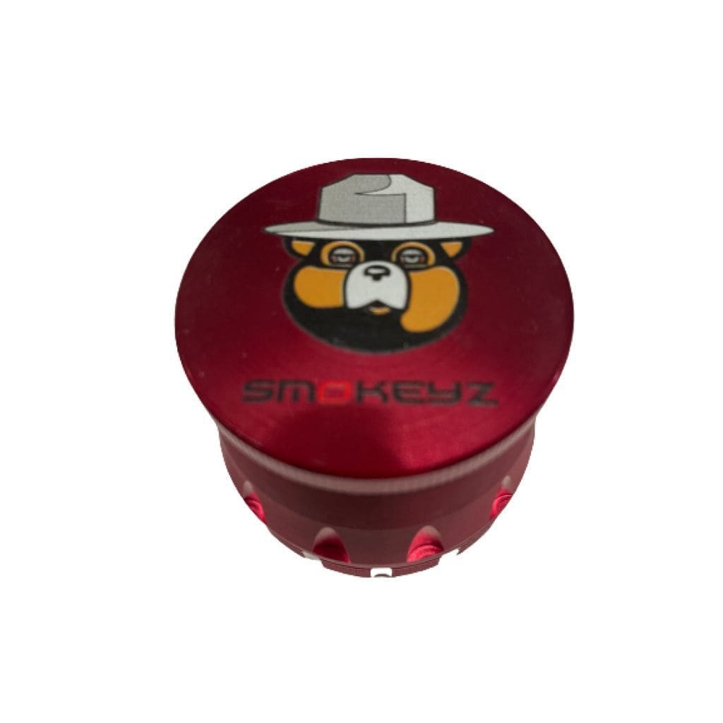 Red Smokeyz metal grinder with cartoon bear hat, clear lid, best weed grinders