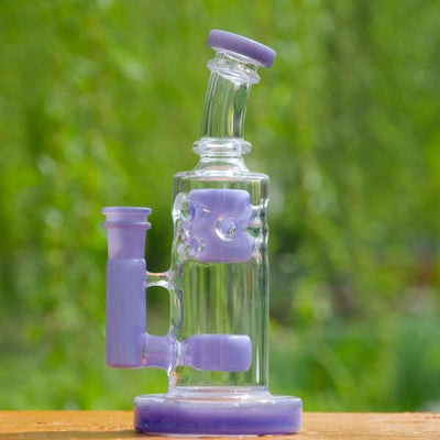 Glass water pipe with purple accents and unique shape featuring a 14mm male quartz banger