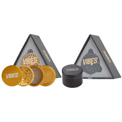 Vibes x Aerospaced 4-piece grinders in gold and black with anodized finish in triangular boxes