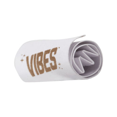 A rolled-up white towel with ’VIBES’ in gold from Vibes Tips Booklet: Enhance Your Rolling Experience