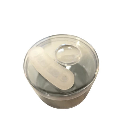 Clear 3.5-inch glass stash jar with lid holding translucent cylindrical insert for glass hand pipe and vaporizers